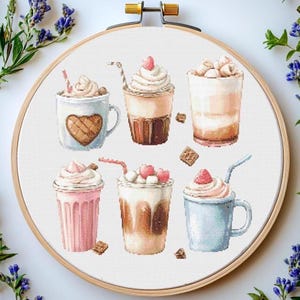 May include: Six different types of iced coffee drinks with whipped cream and toppings. The drinks are in various colours, including brown, pink, and blue. The drinks are arranged in a circle on a white background.