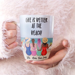 May include: White ceramic mug with a black and white graphic of four women in swimsuits sitting on a beach. The text "Life is better at the beach!" is printed on the mug. The names "Lola, Nina, Sam, Jenny" are printed below the graphic.