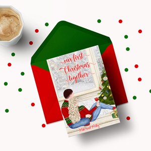 May include: A Christmas card featuring a couple in winter attire sitting by a window with a decorated Christmas tree. The text reads "our first Christmas together" with the names Mike and Molly at the bottom.