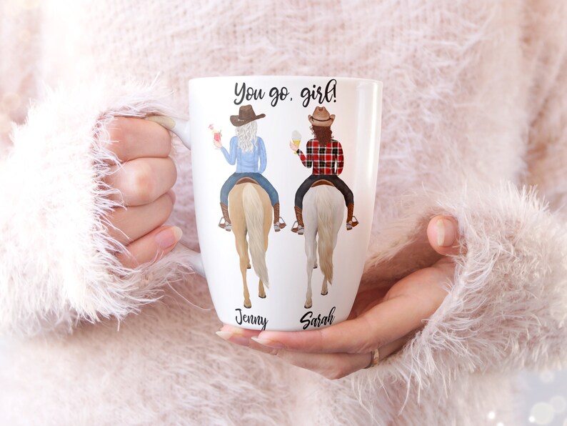 May include: White ceramic mug with a design of two women riding horses. The text "You go, girl!" is printed on the mug. The names "Jenny" and "Sarah" are printed below the women.