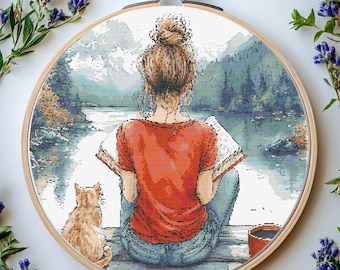 Schema punto croce per ragazza che legge un libro: scena in riva al lago (schema PDF)