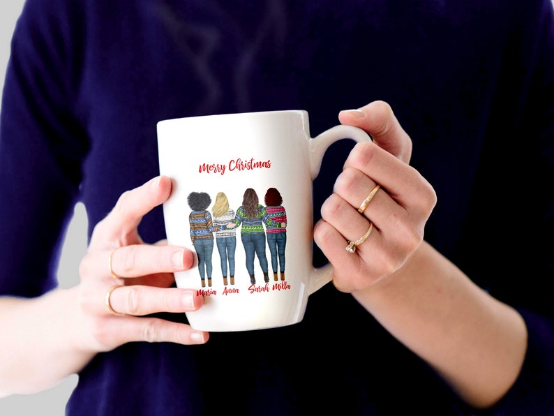 May include: White ceramic mug with a red "Merry Christmas" message and a graphic of four women wearing festive sweaters. The women's names are written below the graphic: "Maria, Anna, Sarah, Melissa".