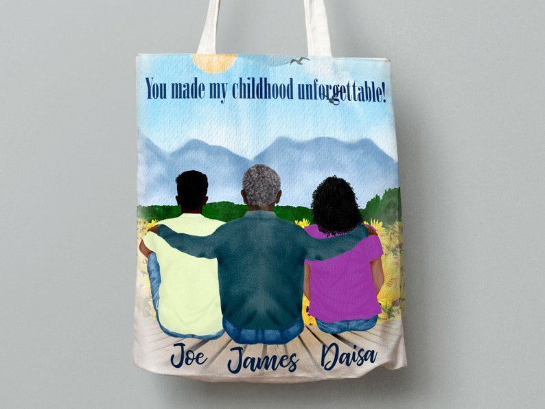 May include: A white tote bag featuring a watercolour illustration of three people seated on a wooden jetty. The individuals are facing away from the viewer with their arms around each other. The backdrop is a blue sky with white clouds and green mountains. The text "You made my childhood unforgettable!" is printed on the bag. The names "Joe", "James", and "Daisa" are printed beneath the figures.