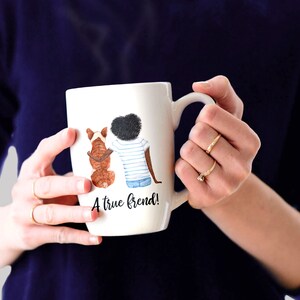 May include: White ceramic mug with a watercolor illustration of a person and a dog sitting back to back. The text "A true friend!" is printed on the mug.
