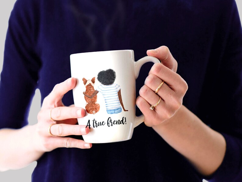 May include: White ceramic mug with a watercolor illustration of a person and a dog sitting back to back. The text "A true friend!" is printed on the mug.