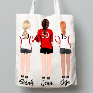 May include: White tote bag with three female figures wearing red and white volleyball uniforms with numbers 5, 30, and 15. The names Sarah, Jenn, and Deja are printed below the figures.
