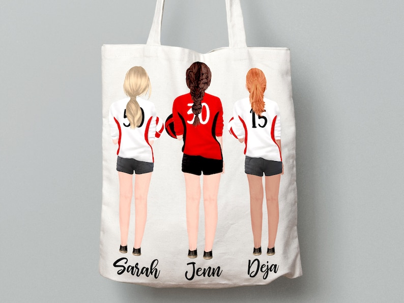May include: White tote bag with three female figures wearing red and white volleyball uniforms with numbers 5, 30, and 15. The names Sarah, Jenn, and Deja are printed below the figures.