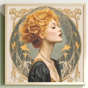 May include: Framed art print featuring a woman with golden-orange hair in profile. The artwork has a vintage style with a teal and gold floral border. The woman wears a black dress and a necklace. The frame is light wood.