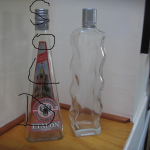 May include: A white ceramic mug with a black handle and the text "But First, Coffee" in a black, bold font. The mug is on a white surface. The mug is likely 11 ounces.