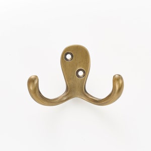 Solid brass wall hooks. Ideal for small spaces to hang coats, clothes and towels. Supplied with fixings. Great bathroom decor hooks