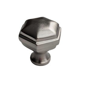 May include: A silver hexagonal cabinet knob with a smooth, brushed finish.