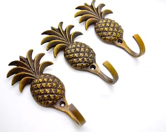 Tropical pineapple wall door hooks. Sold in singles. Brass towel clothes hooks that are perfect for bathroom or bedroom decor projects