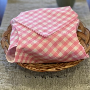 May include: Pink and white gingham fabric in a woven basket. The fabric is folded in half and has a small tag that says "Love You Big Handmade".