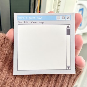 May include: A white notepad with a blue title bar that says "Have a great day!" and the words "File Edit View Help". The notepad has a gray border and a white interior with a gray border around the writing area. There are minimize, maximize, and close buttons in the title bar. There are up and down arrows on the right side of the notepad.