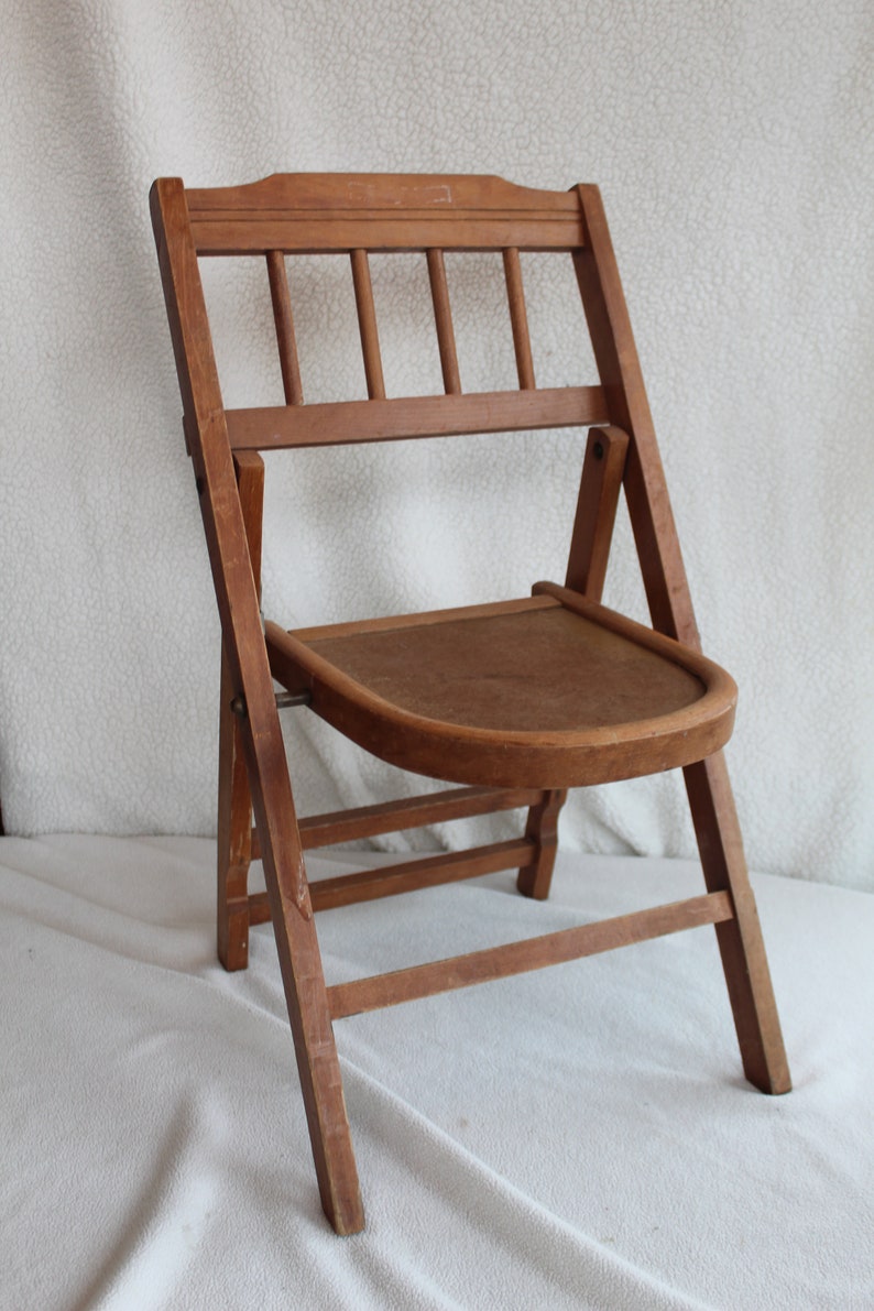 childs wooden chair with arms