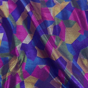 Dotted metallic Fabric with shapes Designs nylon spandex 4 way stretch 60” wide. Purple metallic multicolor shapes