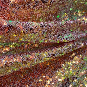 Orange/green Iridescent Mini Sequin Seaweed or Glitz 2mm sequins on stretch pink mesh base Fabric sold by yard