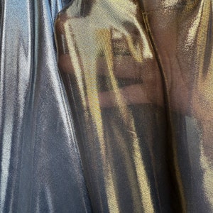 Metallic Chiffon fabric silver and gold color black base. See through fabric, sold by the yard (60” wide)