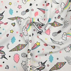 Wonderland unicorn print white nylon spandex base fabric 4 way stretch 60” wide fabric sold by yard