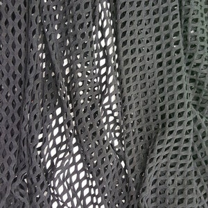 May include: Black mesh fabric with a diamond pattern. The fabric is soft and stretchy.