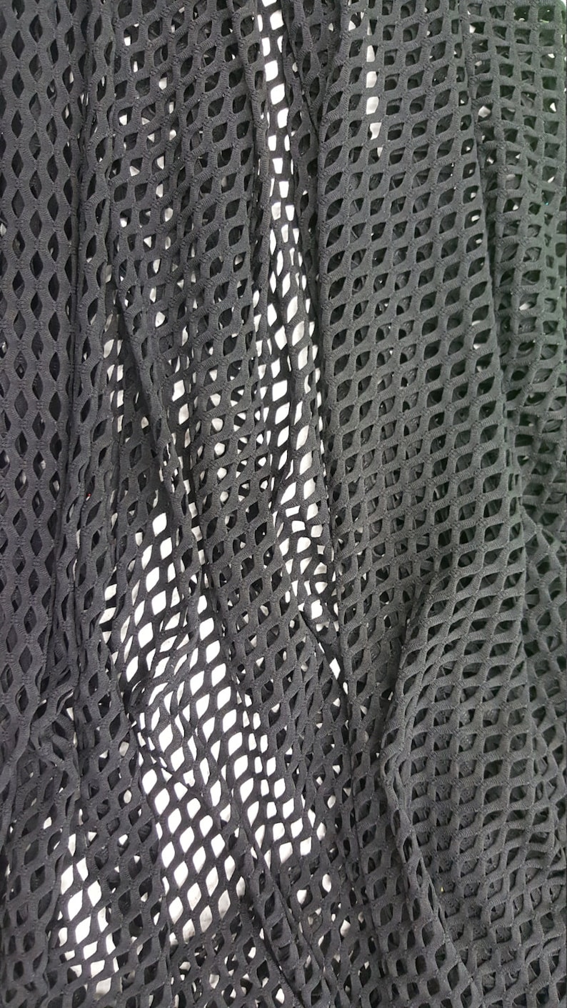 May include: Black mesh fabric with a diamond pattern. The fabric is soft and stretchy.