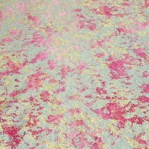 May include: A textured background with a mix of silver, pink, and gold colors. The background has a speckled appearance.