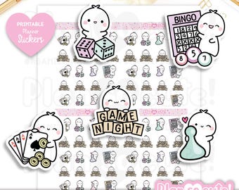 May include: Printable planner stickers with a game night theme. The stickers include dice, a bingo card, a game piece, and the words "Game Night".