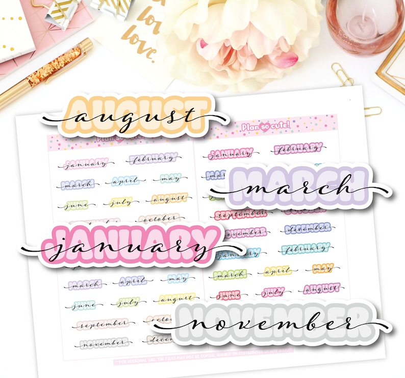May include: A collection of colorful planner stickers featuring the months of the year. The stickers include the months "August", "March", "January", and "November" in bubble letters. Smaller stickers list all months in a cursive font.