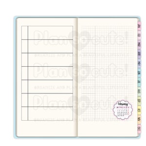 May include: A planner with a gridded page and a calendar for February. The planner has a blue cover and the calendar is in a pink circle with a white border.