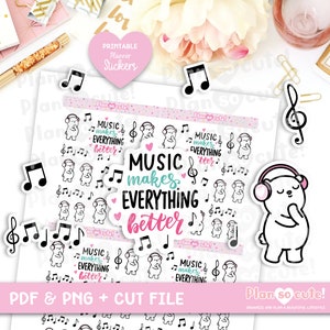 以下が含まれることがあります： ピンク、ブルー、ブラックのテキストで「音楽はすべてをより良くする」というフレーズが書かれたヘッドホンをつけた白いクマが描かれた、印刷可能なプランナー用ステッカー。ステッカーには、音符とトレブルクレフも含まれています。