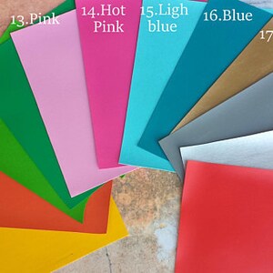 May include: A fan of colorful paper sheets in various shades, including yellow, orange, lime green, Kelly green, pink, hot pink, light blue, blue, gold, gray, silver, and red. Each sheet is labeled with its color name.