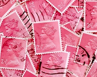 May include: A close-up of a pile of pink postage stamps featuring a portrait of a woman wearing a crown. The stamps have the text "2 1/2 P" and "22" printed on them.