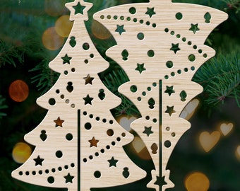 May include: Two wooden Christmas tree ornaments with intricate cut-out designs. The trees are decorated with stars, circles, and dots.