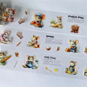May include: A sheet of clear washi tape with illustrations of mice baking bread. The tape features different types of bread, including "Breaking Bread", "Kalmonia", "Daily Bread", and "Sourdough".