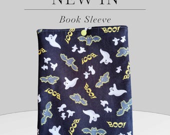 May include: Black book sleeve with a repeating pattern of white ghosts and bats with yellow "BOO!" text.