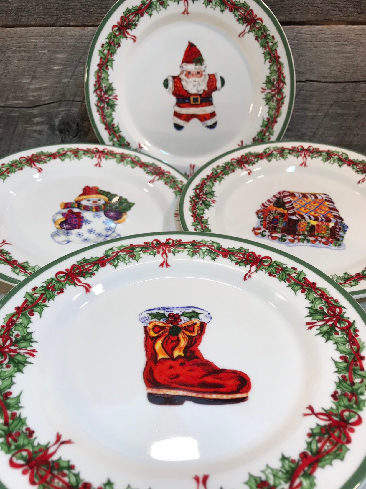 Set of 4 (Four) SALAD PLATES in the Holiday Celebrations (Green Trim) Pattern by Christopher Radko, Santa, Boot, Gingerbread House, Snowman,