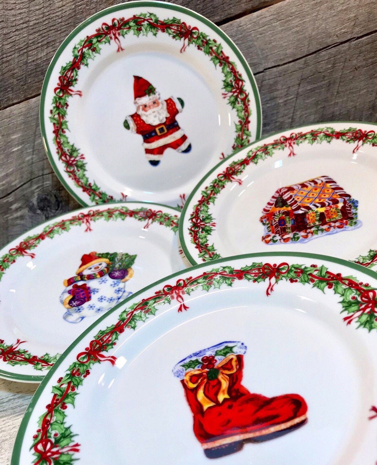 Set of 4 (Four) SALAD PLATES in the Holiday Celebrations (Green Trim) Pattern by Christopher Radko, Santa, Boot, Gingerbread House, Snowman,