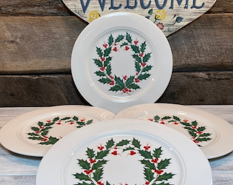 May include: Set of four white ceramic dinner plates with a green holly wreath and red berries design.