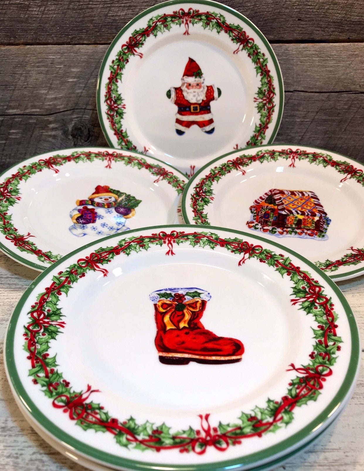 Set of 4 (Four) SALAD PLATES in the Holiday Celebrations (Green Trim) Pattern by Christopher Radko, Santa, Boot, Gingerbread House, Snowman,