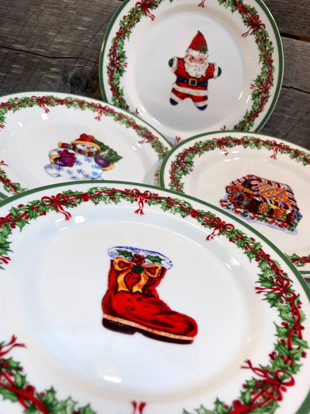 Set of 4 (Four) SALAD PLATES in the Holiday Celebrations (Green Trim) Pattern by Christopher Radko, Santa, Boot, Gingerbread House, Snowman,