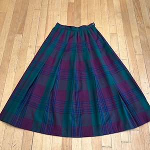 May include: A pleated skirt in a green, purple and blue tartan pattern.