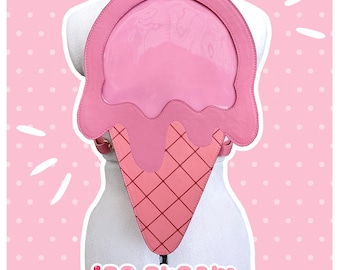 May include: A pink ice cream cone shaped backpack with a clear plastic window on the front. The backpack has the text "ice cream ita bag" and "by arrupako" printed on the bottom.
