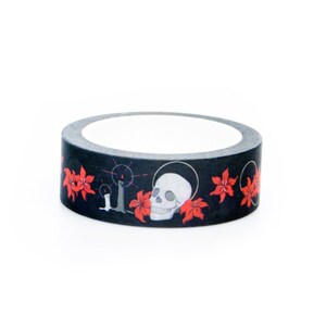May include: A roll of black washi tape with a skull and red flowers design.