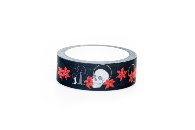May include: A roll of black washi tape with a skull and red flowers design.