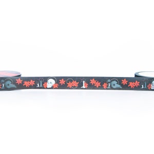 May include: Black and red washi tape with a repeating pattern of skulls, candles, and flowers.