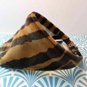 May include: A brown and black striped fabric dog collar with gold metal buckles.