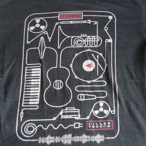 May include: Dark gray t-shirt with a white graphic design featuring musical instruments and recording equipment. The word "RECORDING" is at the top, and "KILLER TRACKS" is at the bottom. The design includes a piano, guitar, and drum set.