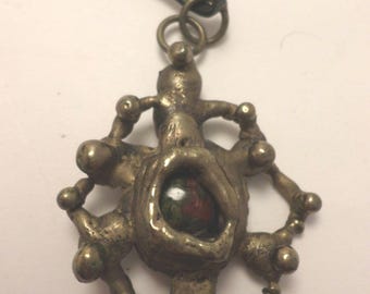 Vintage Brutalist West African Brass abstract pendant with glass center