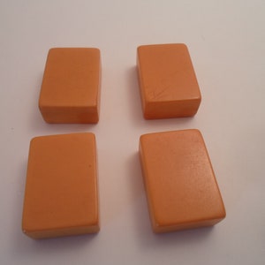 May include: Four rectangular orange tiles, each with a smooth surface.