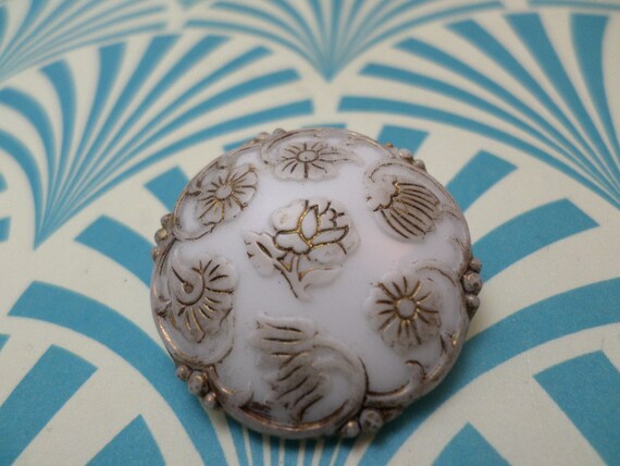 Vintage milk glass button that has been made into a pin gold painted flowers